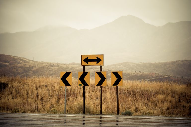 Road signs at the end of the road pointing left and right